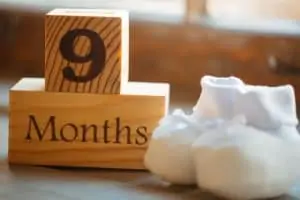 The baby will soon be born 9 months pregnant. Cubes with baby booties.