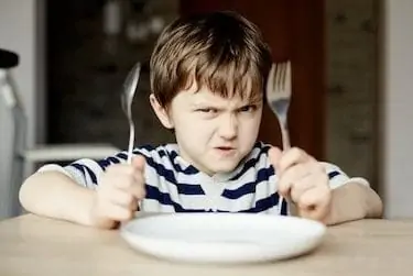 Furious little boy waiting for dinner.