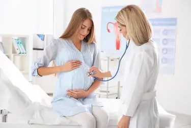 Pregnant woman with her doctor in clinic