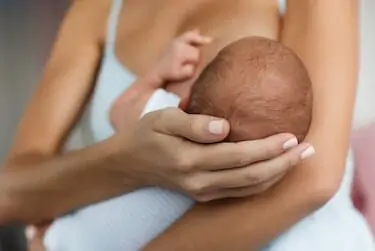 Mother breastfeeding her newborn baby