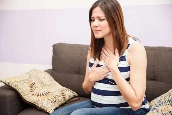 Beautiful pregnant woman suffering from heartburn