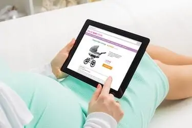 Pregnant woman shopping online on baby store