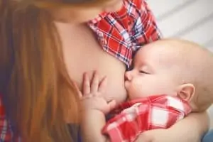 mother breastfeeding her baby toddler