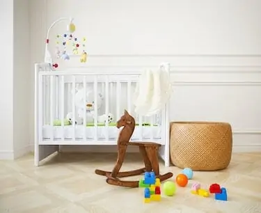 Empty nursery room with basket, toys and wooden horse