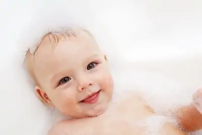 Adorable bath baby boy with soap