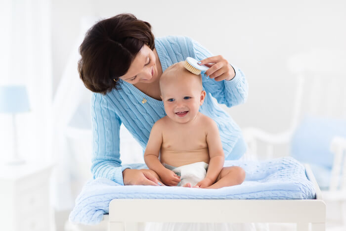 Mother and baby change diaper after bath.