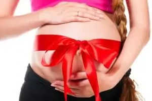 Pregnant woman with red silk bow