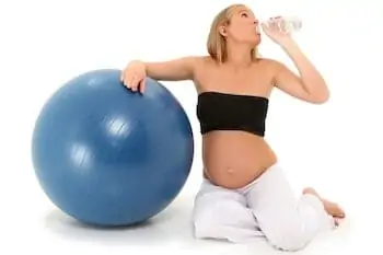 mother to be after workout drinking water