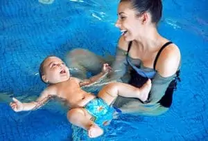 Mother and baby relaxing in the swimming pool