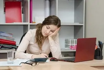 Young girl working at the desk in the office