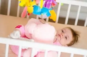 baby playing on crib