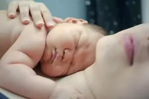 Infant sleep on mom chest