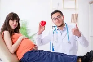 Doc checking pregnant woman