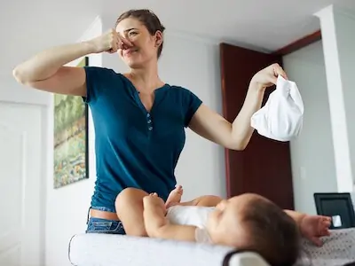 mom changes dirty diaper