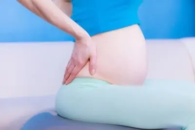 Pregnant woman suffering from hip and back pain