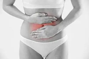 Woman Holding Stomach In Pain