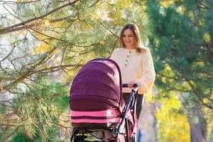 Young mom walks with a stroller