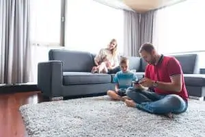 Father, mother and children playing a video game