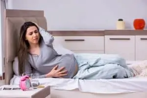 Young pregnant woman in the bedroom