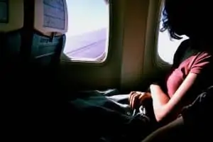 She is flying on an airplane