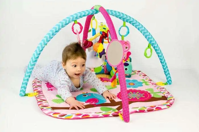 Baby girl on activity gym