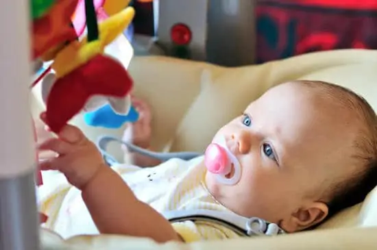 Baby laying in bouncer chair