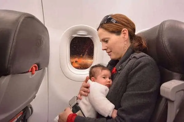 Mother holding her newborn inside of a flight