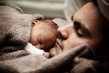 she is sleeping on dad's chest