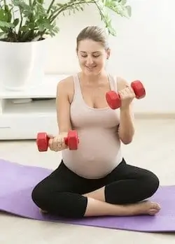 pregnant woman exercise with dumbbells