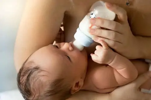 baby having milk from bottle