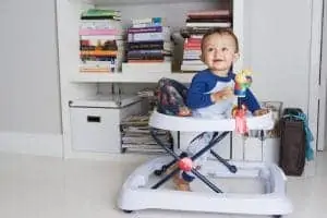 Baby boy playing in a walker