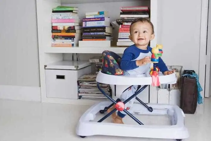 Baby boy playing in a walker