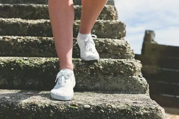 Woman is walking down some steps