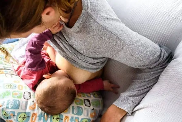 Adorable newborn baby breastfeeding