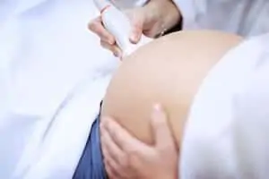Doctor making ultrasound for pregnant woman