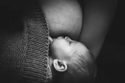 mom holding her baby while breastfeeding