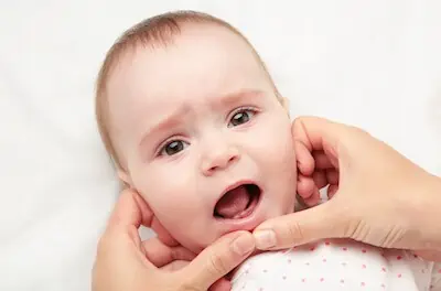 mom checking baby first teeth