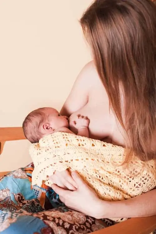 Mom breastfeeds her newborn baby