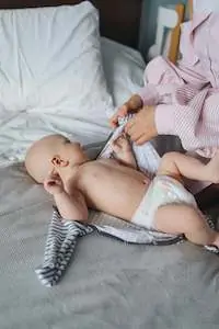 newborn lying on bed