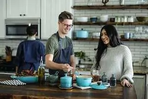 two people cooking