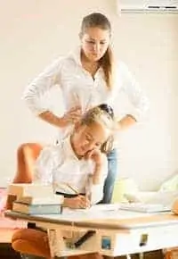 mom watching at daughter doing homework