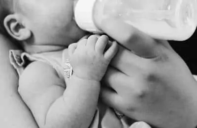 mom feeding her baby with bottle