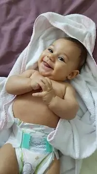 smiling baby in diaper