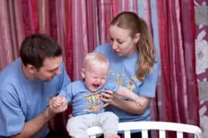 baby crying in-front of parents