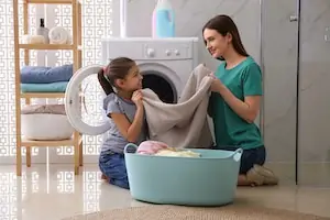 kid helping mom in laundry