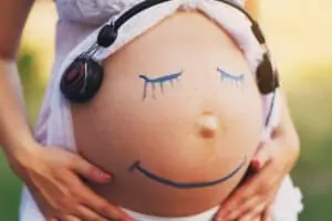 smile funny face on pregnant belly