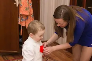 Mother helps daughter get ready for school