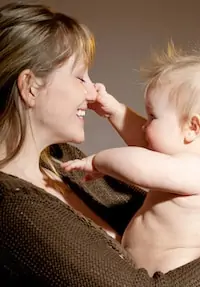 baby touching mom face