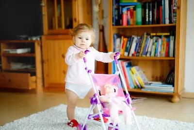 baby uses walker on carpet floor