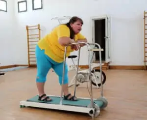 fat woman exercises on treadmill